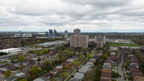 Aerial-shot-flying-forward-through-grey-and-overcast-Toronto-neighborhood-in-early-spring-time