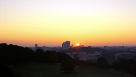 time lapse sunrise over munich. sun rises over the bavarian capital city. view from a green park in summer