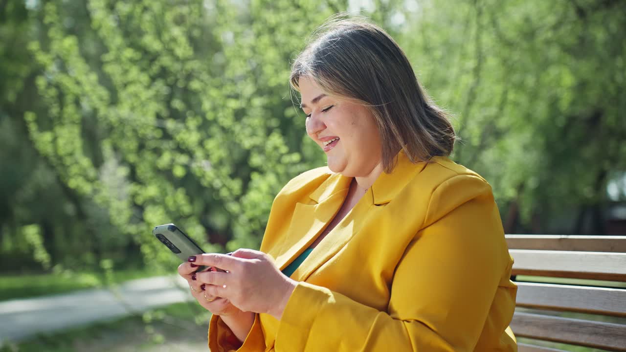 Woman using phone in a park