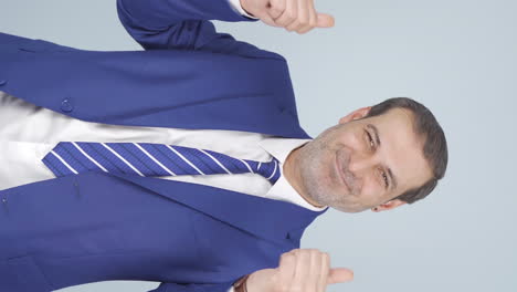 Vertical-video-of-Businessman-giving-positive-affirmation-looking-at-camera.