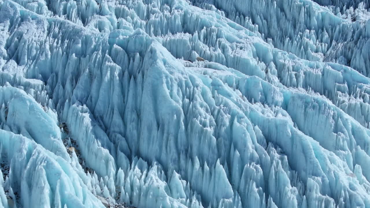 Snow-packed layers of Khumbu Glacier at Everest Base Camp, Nepal. Melting ice, high-altitude tents, thorny snow peaks, and Sagarmatha’s iconic summit breathtaking Himalayan exploration, Drone view