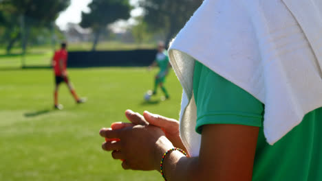 Coach-applauding-and-gesturing-to-football-players-4k