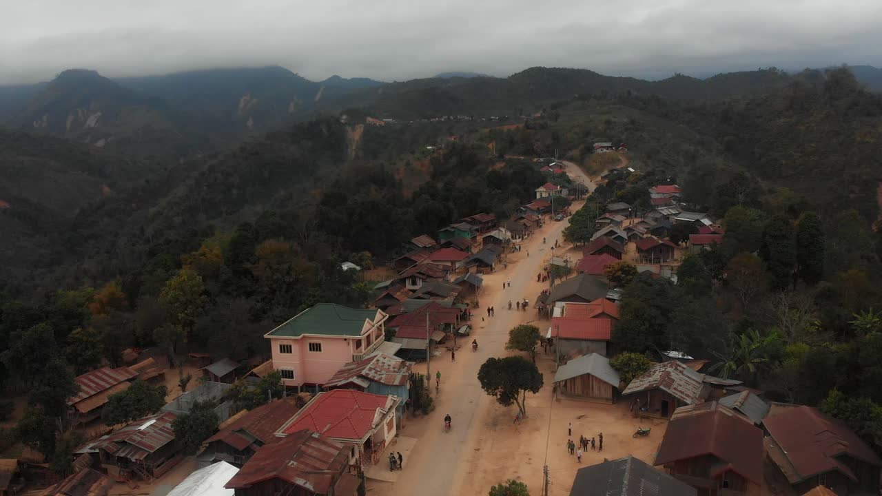 Village houses on a dusty road, Khwaeng Hua Phan, Laos