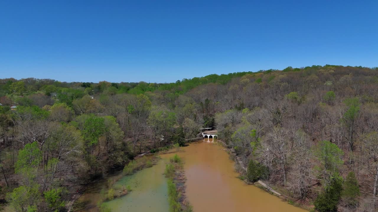 Aerial footage of drone flying toward the mouth of Dunbar Cave at Dunbar Cave State Park in Clarksville Tennessee