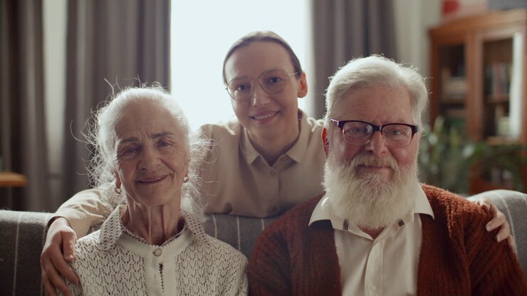 Portrait of Young Woman Embracing Grandparents and Smiling at Camera