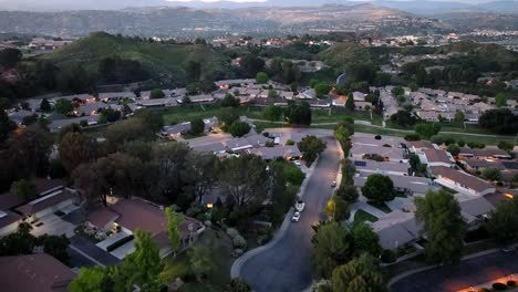 santa clarita neighborhood of homes at golden hour sunset, aerial forward of houses