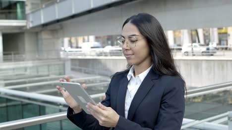 focused businesswoman with tablet pc outdoors