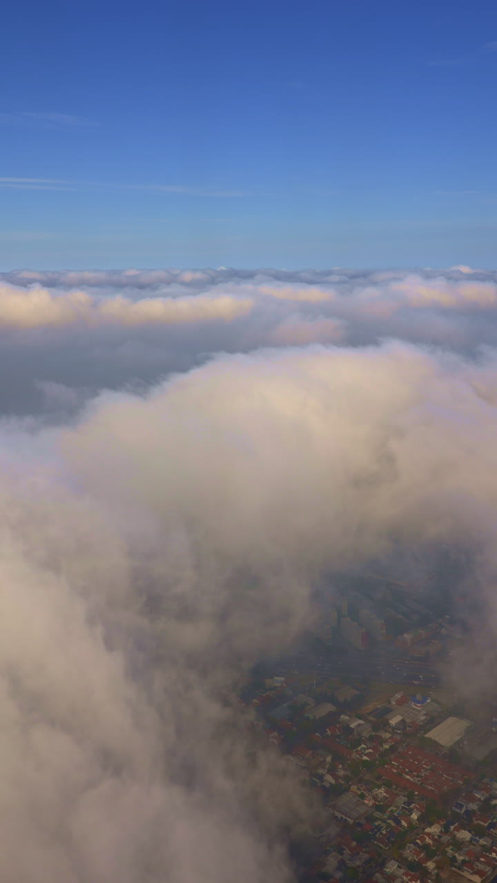Aerial View of Fluffy Clouds Above a City