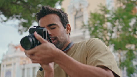 man photographing city views at summer vacation closeup. guy taking picture town