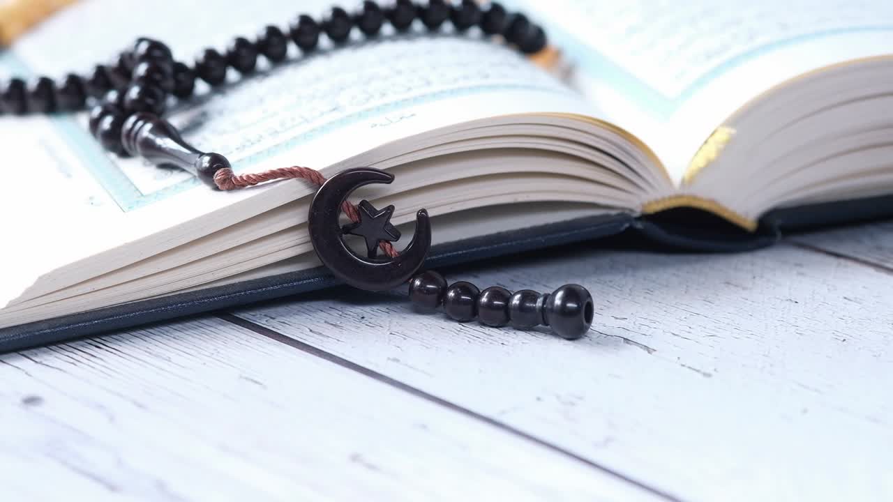 libro sagrado corán y cuentas de oración en la mesa, cerca.