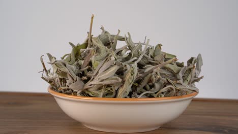 a bowl of dried sage sits on the table