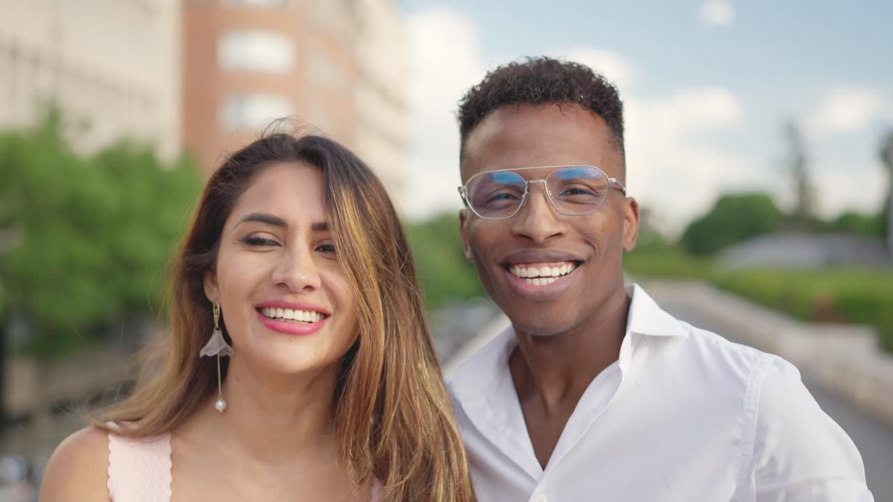 A happy diverse couple smiling and laughing outdoors