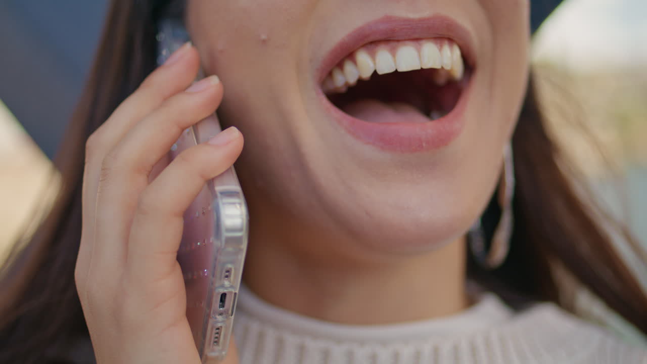 Closeup girl face calling mobile phone outdoors. Happy emotional woman speaking