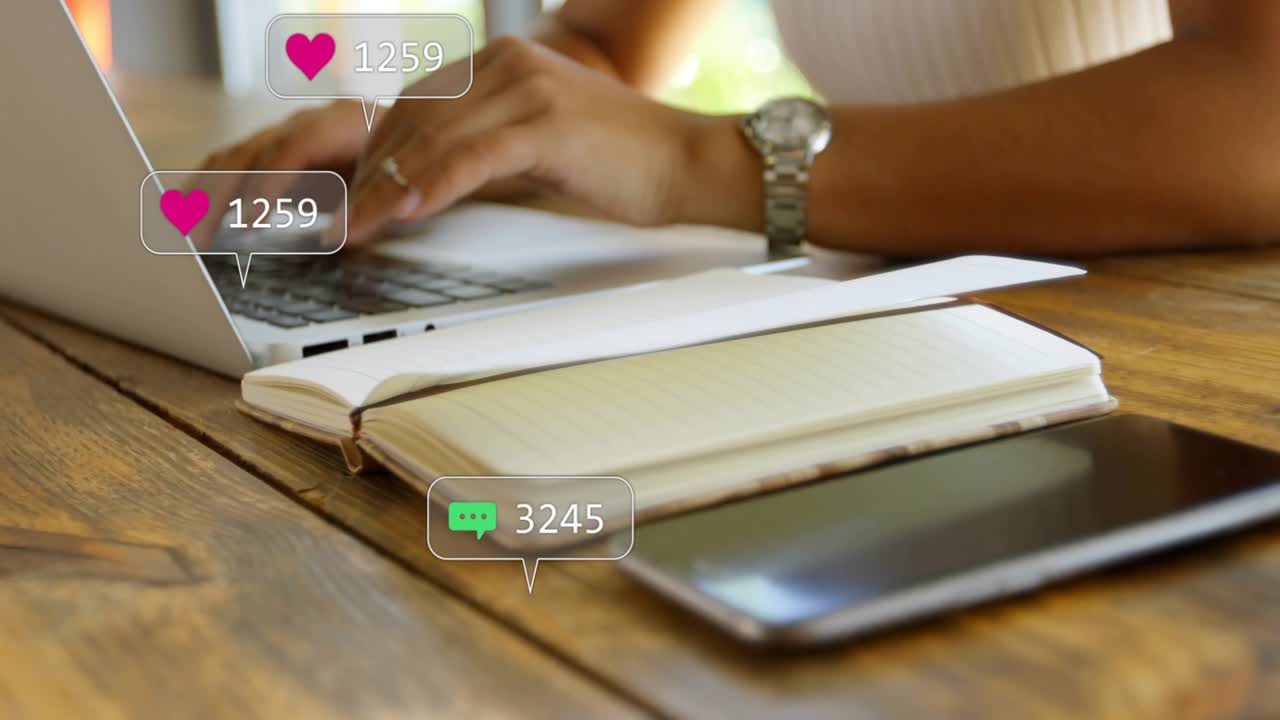 Woman typing on laptop and showing social media icons and rising counters from phone, notebook