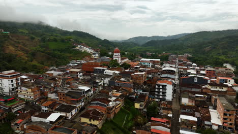 Aerial-view-approaching-the-St-Raphael's-Church-in-cloudy-Antioquia,-Colombia