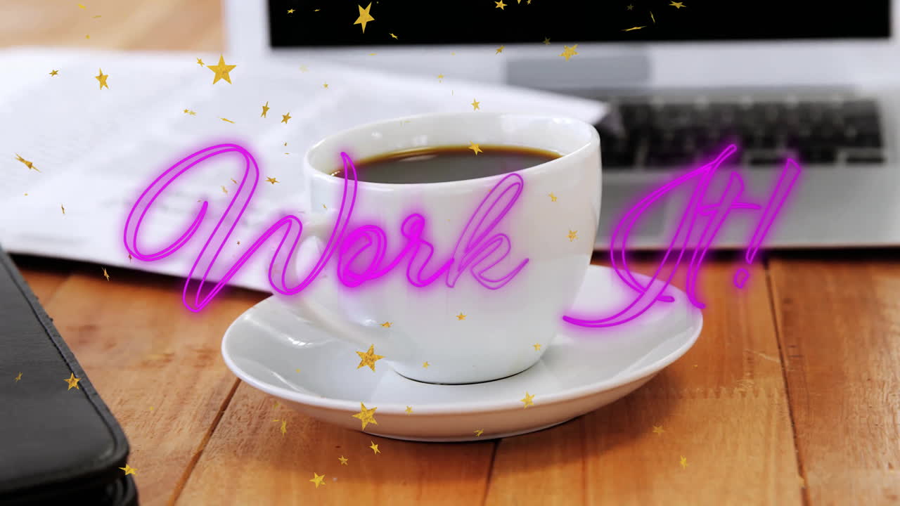White ceramic coffee cup resting on wooden desk while neon Work It! script glowing around