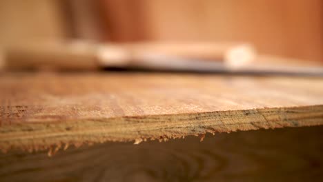 A-slow-motion-shot-of-blowing-away-sawdust-on-a-freshly-cut-piece-of-wood