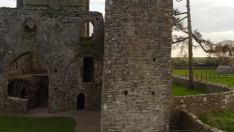 dynamic tracking shot reveals bective abbey towers, windows and doors