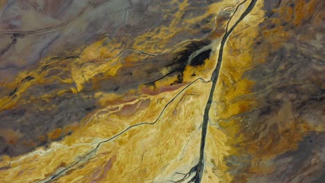 aerial over surrealistic industrial open pit mine. topdown