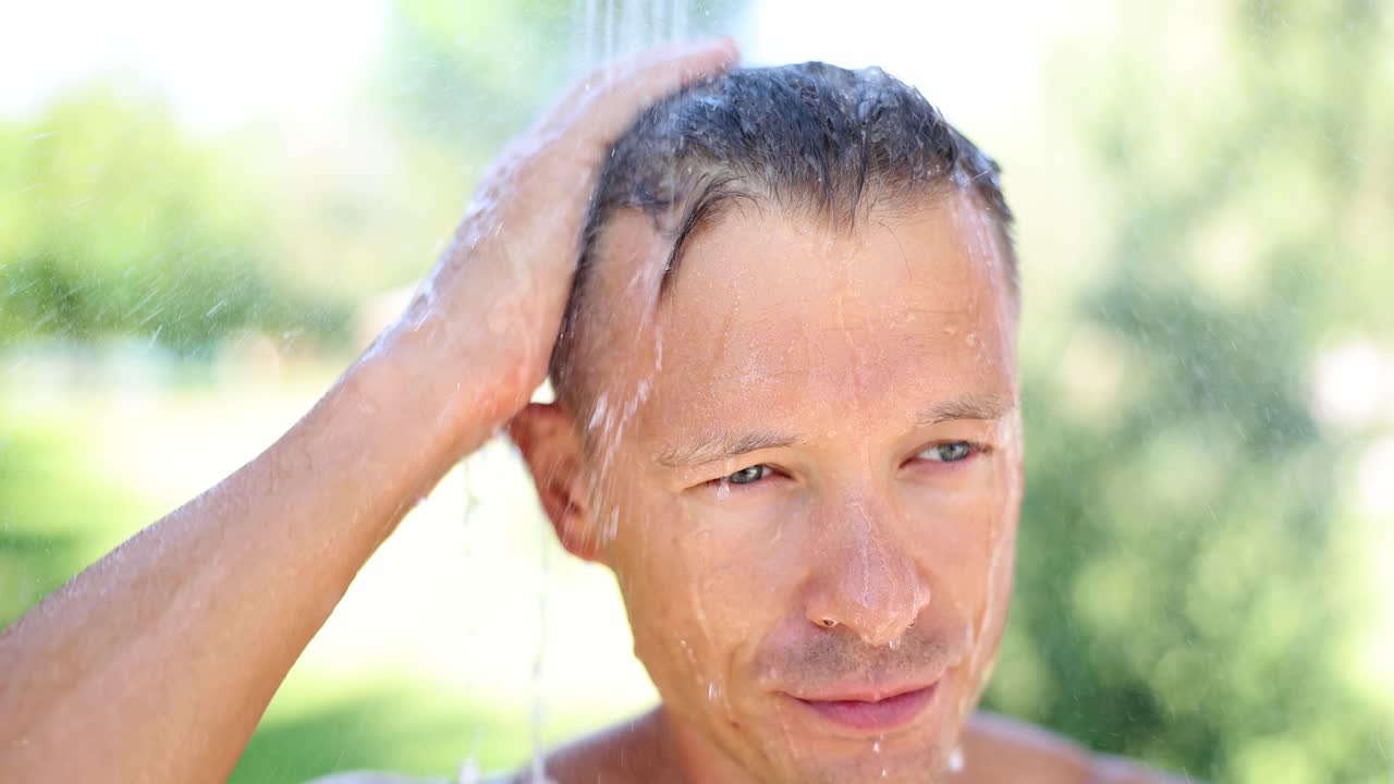 Man Taking an Outdoor Shower