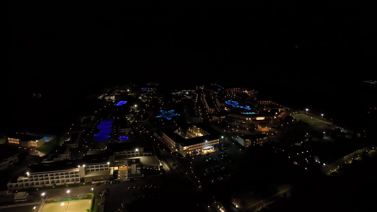 Aerial view away from illuminated hotels on the coast of Rhodes, night in Greece