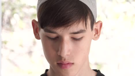 arab muslim teen with traditional islamic kufi hat