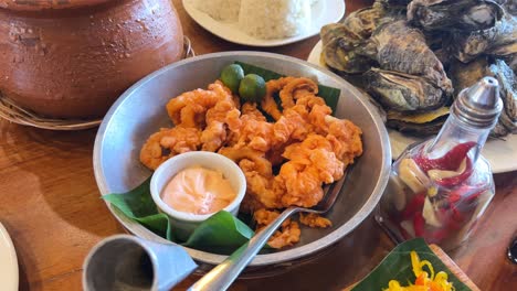golden fried calamari with dip, fresh oysters, and rice served filipino-style—ideal for food promos and culinary features