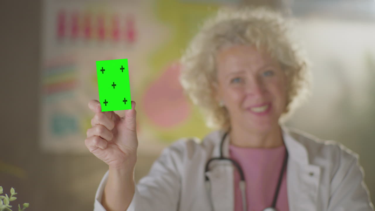 Doctor Holding a Green Screen Card