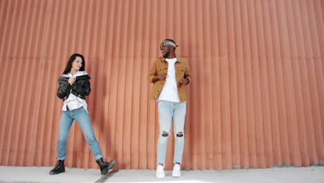 couple dancing in front of orange wall