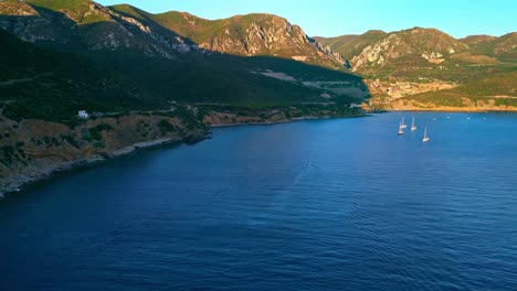 cinematic drone shot of sailing boats at blue lagoon, masua beach, sardinia, italy