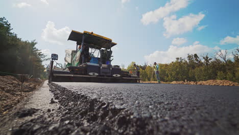countryside asphalt repair. constructing asphalt road, construction with steamroller