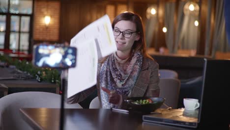 people and blogs, female nutritionist blogger influencers talks about good nutrition, shows vegetarian salad of fresh vegetables during live broadcast for vlog, proper nutrition