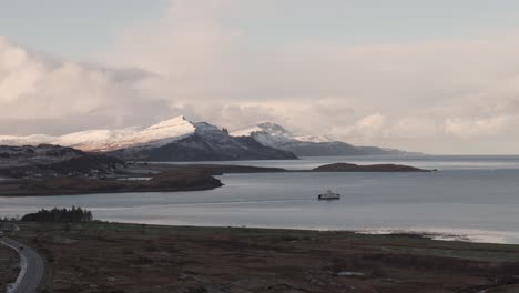 stunning view of scotland's mountains overlooking the sea, combining rugged highland terrain with sweeping coastal vistas. the landscape features dramatic peaks, hills, and the glistening water below