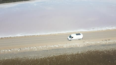 drone aerial moving backwards over pink lake macdonnell in south australia