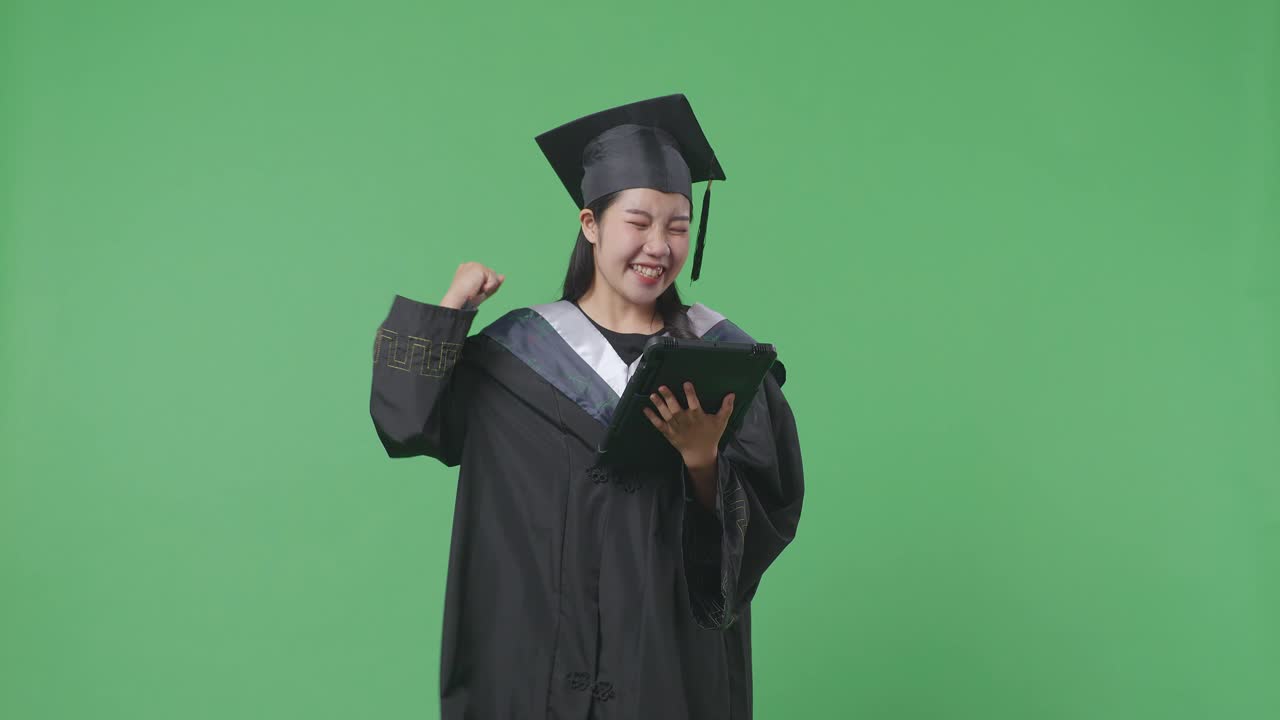 graduado emocionado celebrando con la tableta