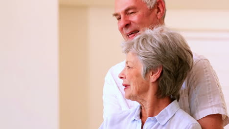 Happy-senior-couple-standing-and-embracing