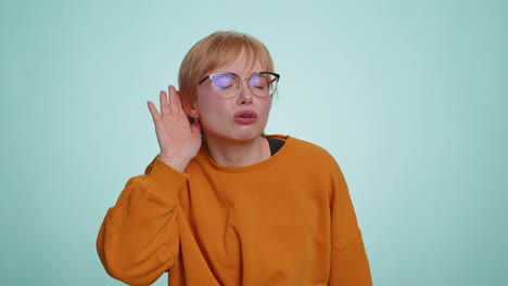 Young woman keeping arm near ear for louder voice asking to repeat to hear information deafness