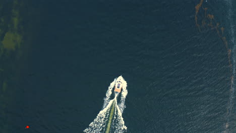 top drone view of motorboat on the sea at sunny summer day