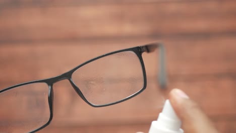 close up of a hand spraying water on glasses