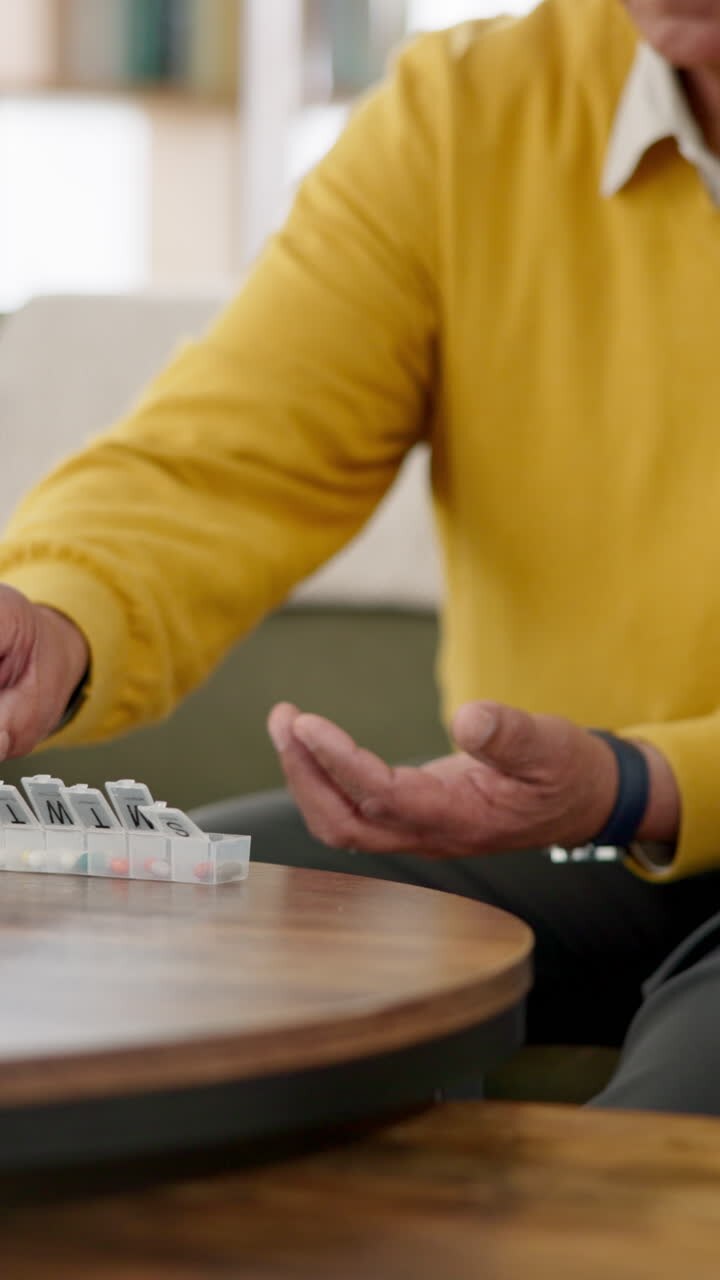 Senior man taking pills from a pill box