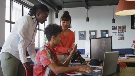 Happy-diverse-business-people-discussing-work-during-meeting-at-office