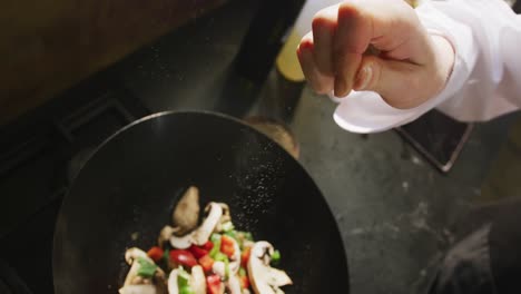 Chef-adding-salt-on-the-vegetables