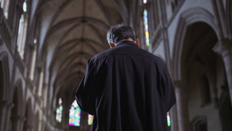 priest praying in a cathedral