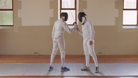 fencer athletes during a fencing training in a gym