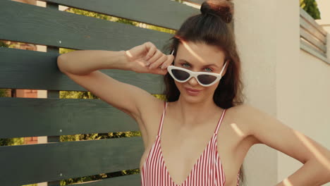 woman in swimsuit with sunglasses