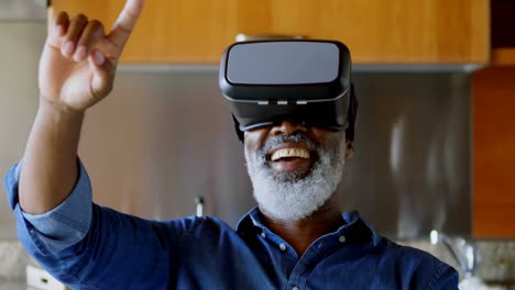Senior-man-using-virtual-reality-headset-in-kitchen-4k