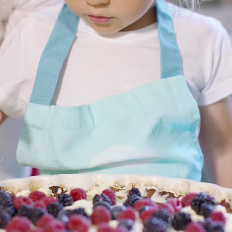 Little-girl-finishing-off-a-homemade-berry-pie