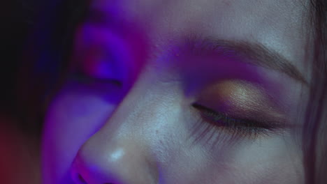 close-up of eyes bathed in neon light