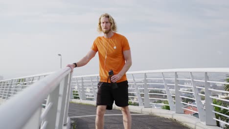 sporty caucasian man training on a bridge