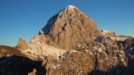 rotating cinematic drone shot of the mangart mountain in slovenia